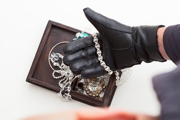 Burglar is stealing expensive jewelry
